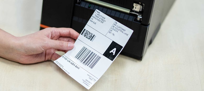 Shipping label being printed from a printer in warehouse